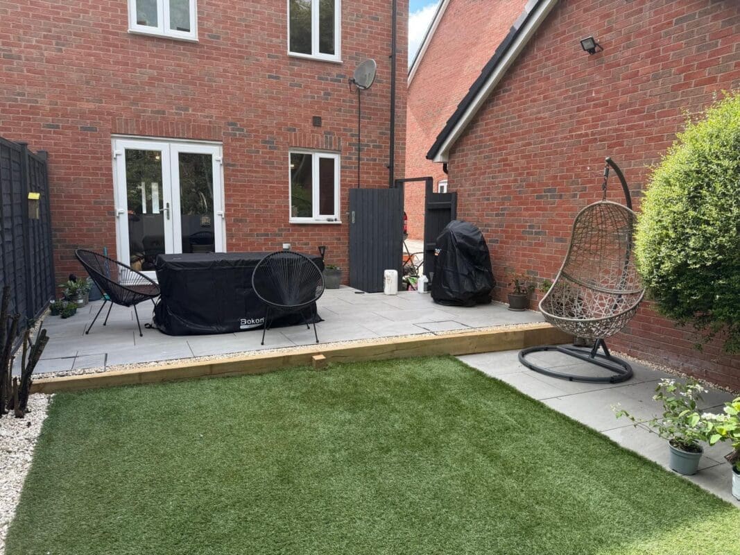 Large-format grey porcelain patio slabs with covered outdoor dining furniture in a Worcestershire garden